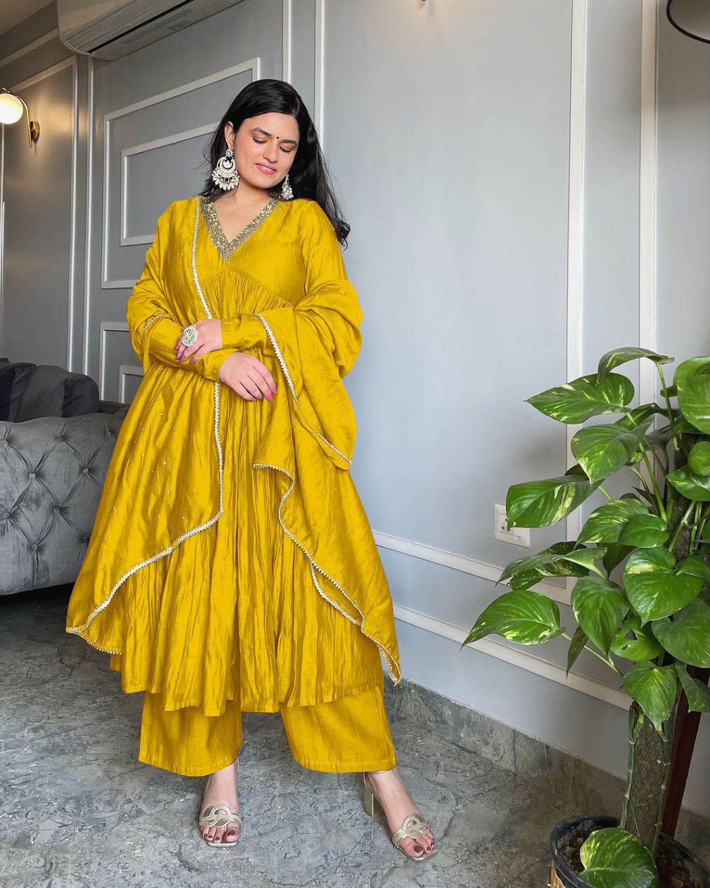 Traditional Yellow Alia Cut gown set with a stylish dupatta featuring rivet moti work and fancy lace.
